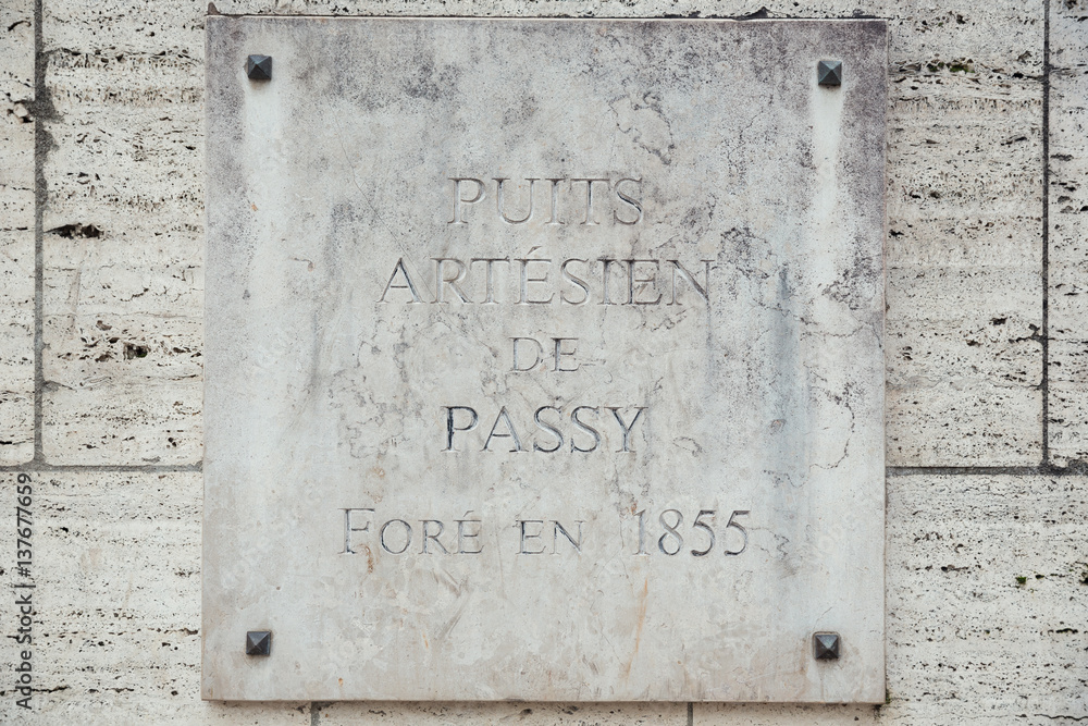Plaque of the natural source of Passy in the middle of Paris Plaque of the natural source of Passy in the middle of Paris