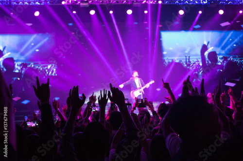 Crowd enjoying concert, large group celebrating new year holiday, party background fun concept, blurred