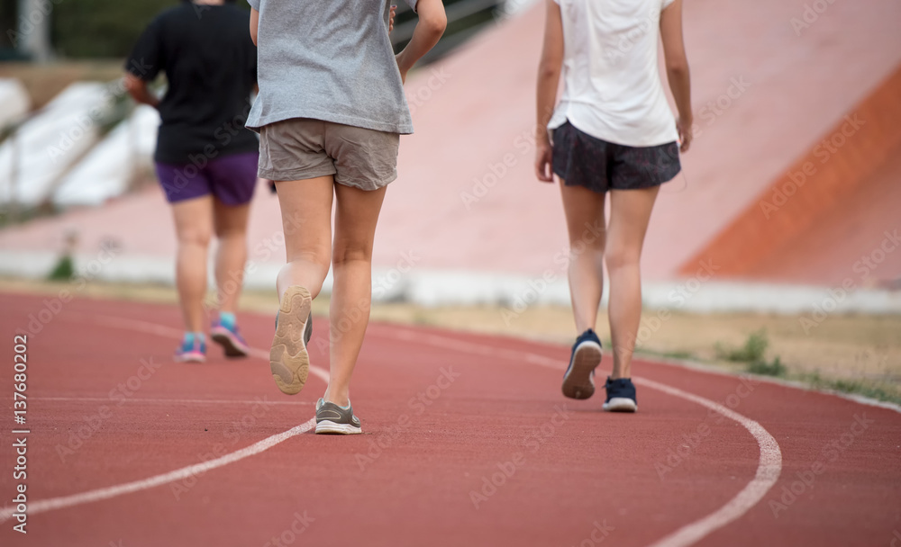 Female runner on the race track practicing Female runner on the race track practicing
