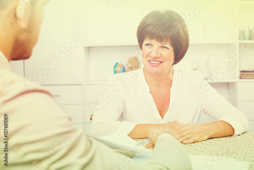 Employer discusses with elderly woman