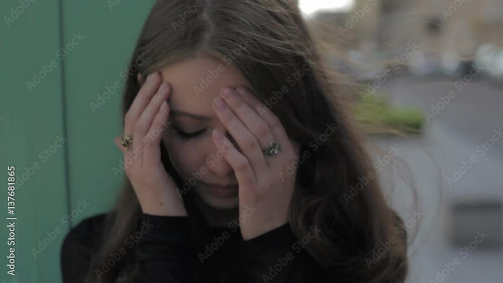 Beautiful sad woman crying in the city. Slow motion. Messy make up mascara on face. Beautiful sad woman crying in the city. Slow motion. Messy make up mascara on face.