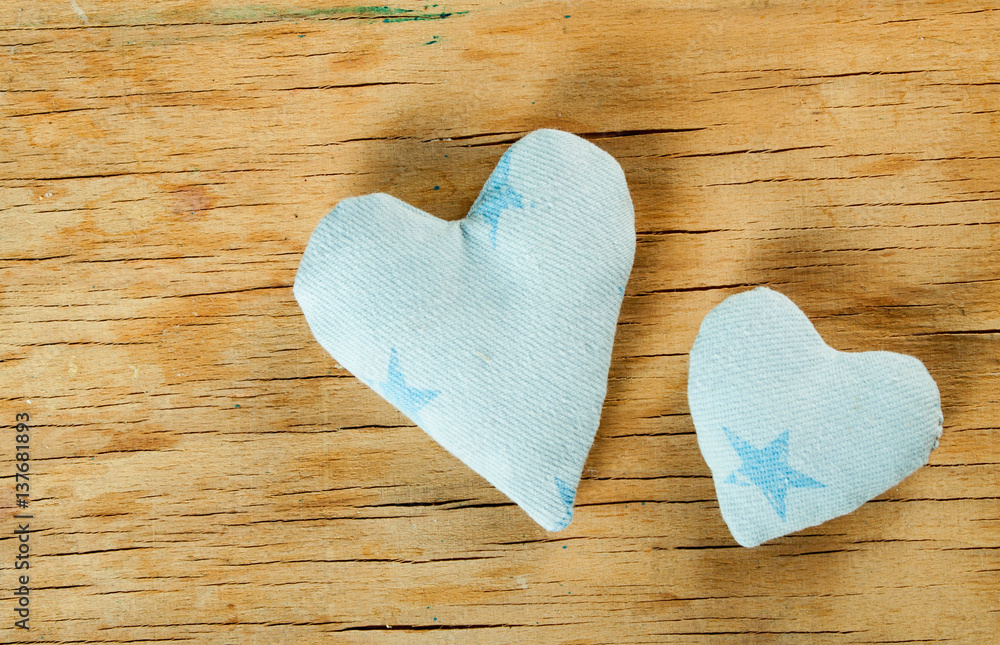 Fototapeta premium Heart from cloth on wood desk