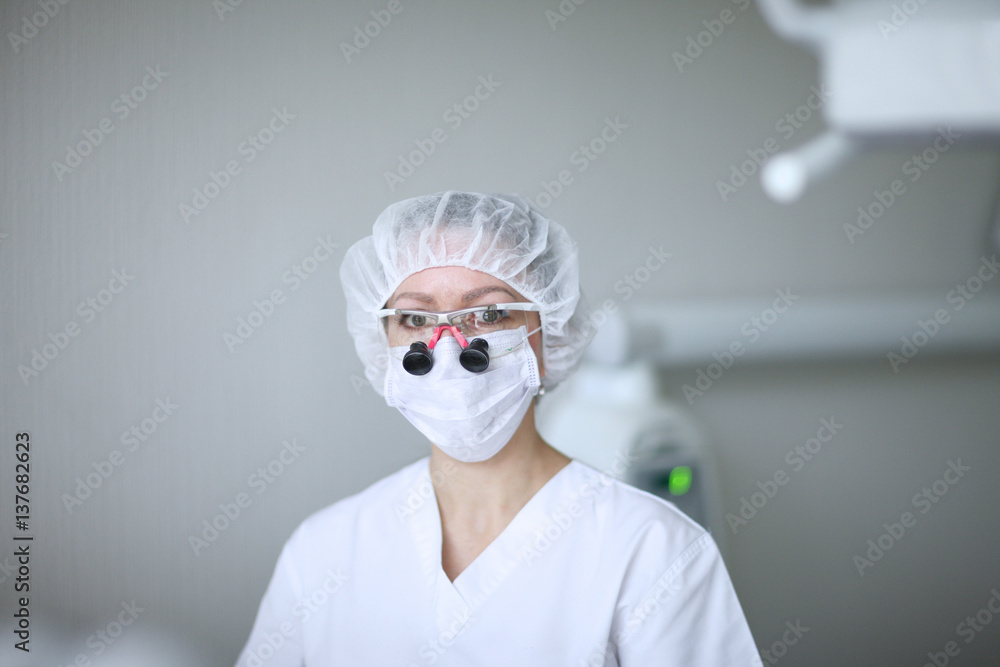 A close look dentist with glasses and a microscope A close look dentist with glasses and a microscope