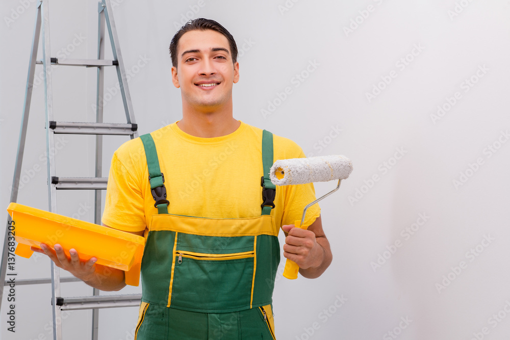 Man painting the wall in DIY concept Man painting the wall in DIY concept