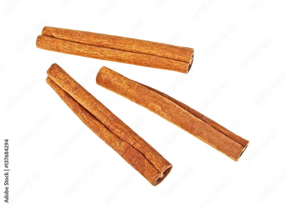 Cinnamon sticks on white background, top view Cinnamon sticks on white background, top view