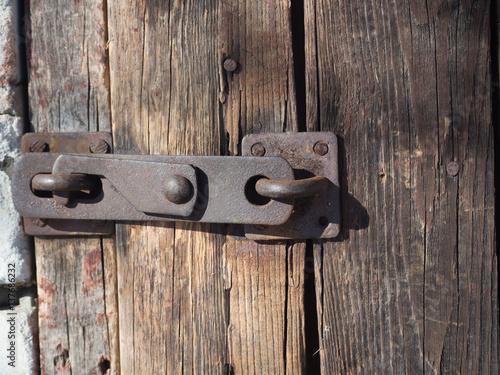 Old lock on the door. lock on the door of an old farmhouse . true village style . close-up. focus on lock photo