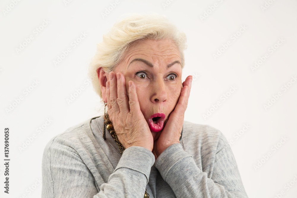 Surprised elderly lady isolated. Female with hands on face. See the unbelievable. Surprised elderly lady isolated. Female with hands on face. See the unbelievable.