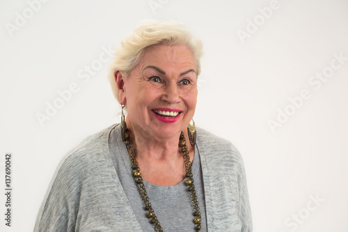 Isolated elderly woman smiling. Lady with happy face expression.