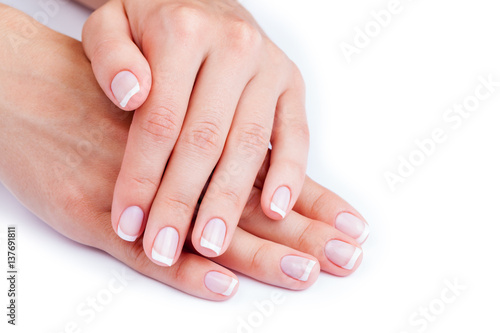 Woman hands with french manicure isolated on a white background