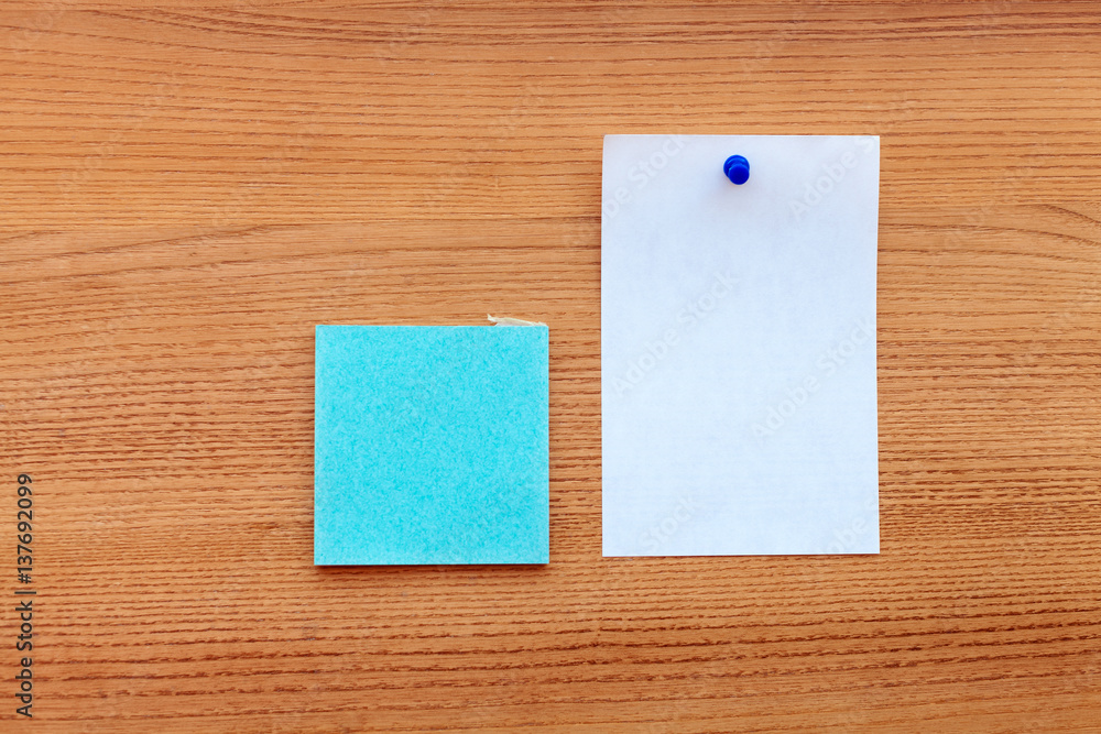 blue sticker with a white paper isolated on a wooden background blue sticker with a white paper isolated on a wooden background