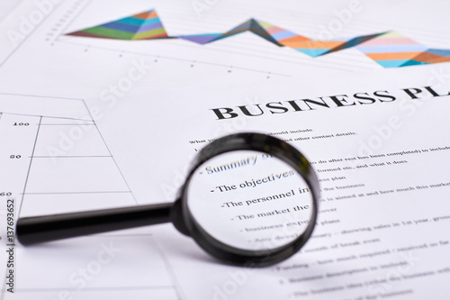 Loupe and documents. Successful business strategy. Business plan.