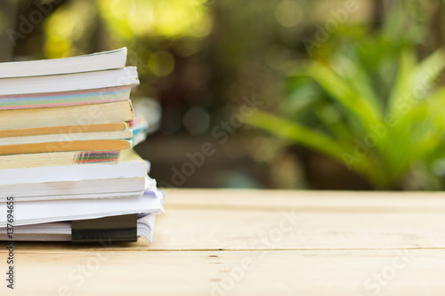Book and paper on wooden table