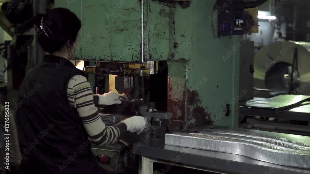 Hard work of the women worker at the forming machine Hard work of the women worker at the forming machine