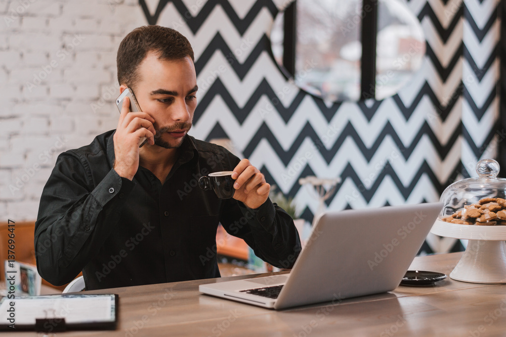 Businessman talking on the phone and drinking coffee. Businessman talking on the phone and drinking coffee.