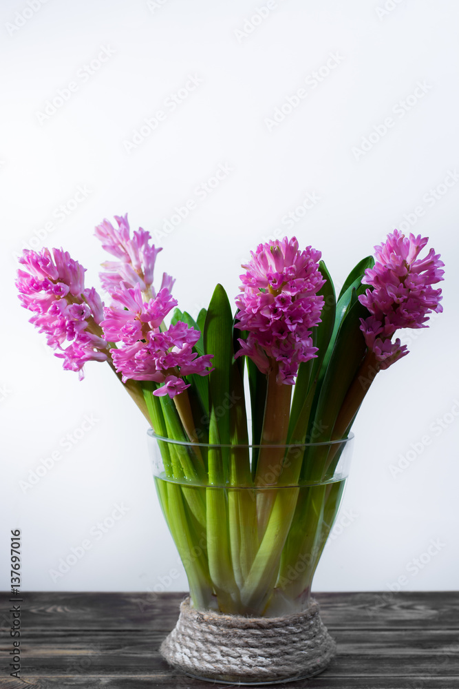 Bright yellow Narcissus flowers bouquet in a yellow glass vase, Easter and spring concept Bright yellow Narcissus flowers bouquet in a yellow glass vase, Easter and spring concept