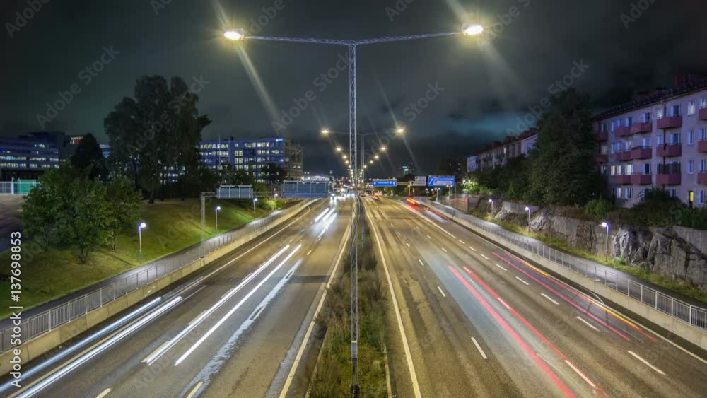 Time Lapse Tilt of freeway at night. Long exposure traffic creating light trails Time Lapse Tilt of freeway at night. Long exposure traffic creating light trails