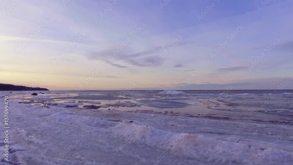 Cracks in baltic sea ice floating and shifting. Coastline. Beach side. Steadicam footage. Slow motion. Cracks in baltic sea ice floating and shifting. Coastline. Beach side. Steadicam footage. Slow motion.