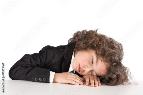 Cute kinky businessman sleeping on the table. Close-up. White background. © kravik93