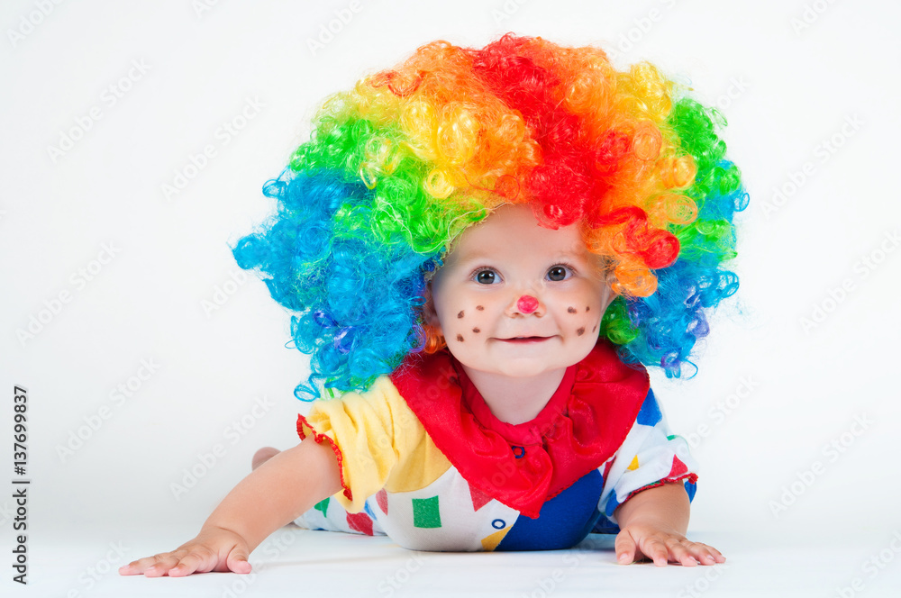 Child clown with a red nose multicolored wig in with balls Child clown with a red nose multicolored wig in with balls