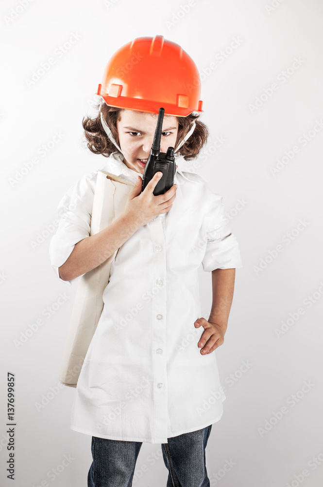 Young curly foreman swearing on the radio, looking down. Gray background. Young curly foreman swearing on the radio, looking down. Gray background.