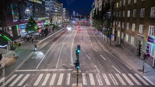 Time Lapse of pedestrian crossing and city street at night. Bus stop, Stockholm, Sweden