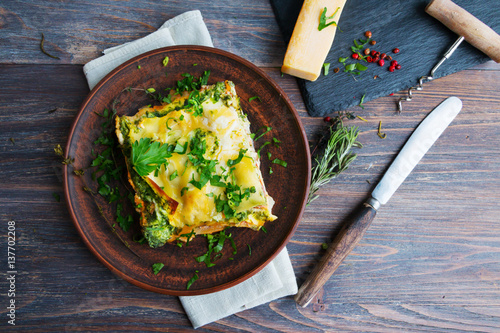 Vegetable lasagne served on ceramic plate - italian cuisine - vegetarian diet. Closeup. Top view.