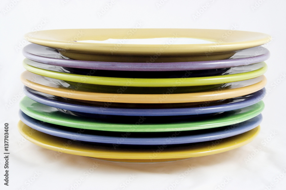 Side view of rims of colorful handmade ceramic plates. Isolated. Side view of rims of colorful handmade ceramic plates. Isolated.