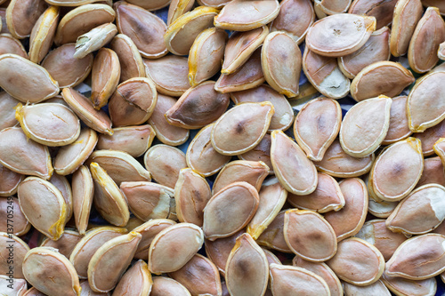 Close-up food background of fried yellow white pumkin seeds
