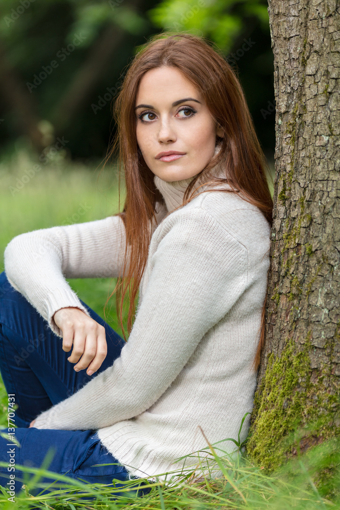 Beautiful Young Woman Sitting Leaning Against Tree Beautiful Young Woman Sitting Leaning Against Tree
