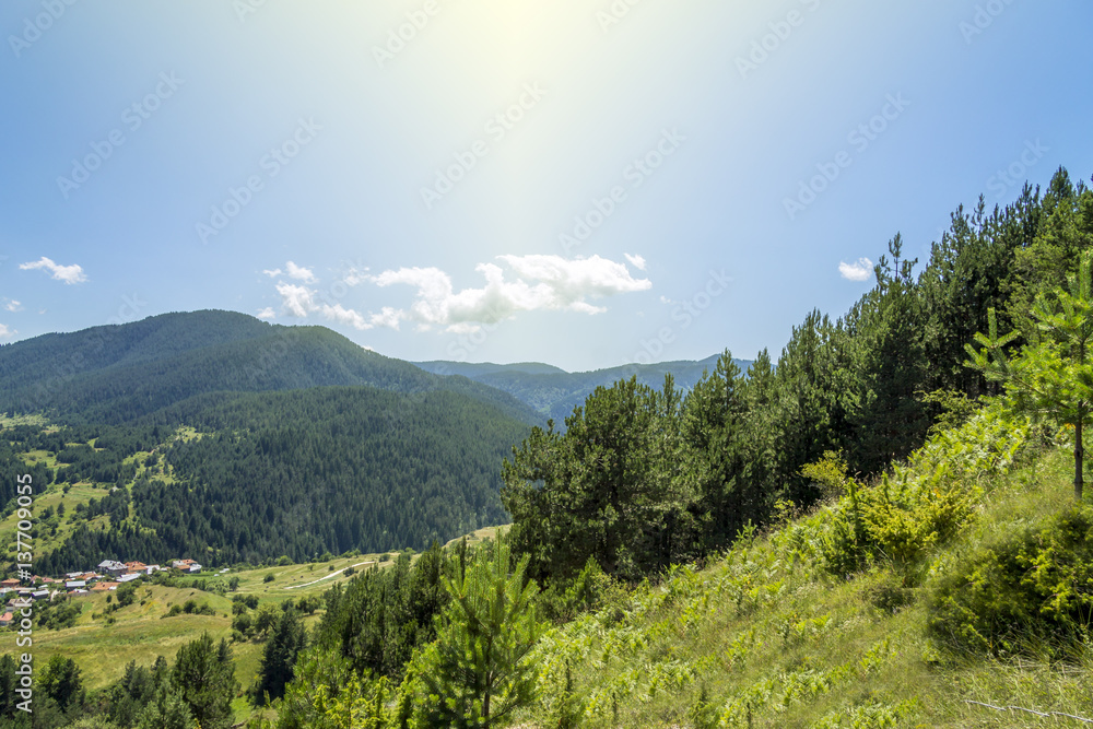 idyllic summer mountain landscape with small village sunlight