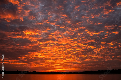 Impressive sunrise with clouds over Rio Negro, Anavilhanas Archipelago, Brazil