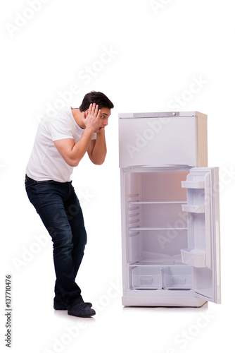Man looking for food in empty fridge