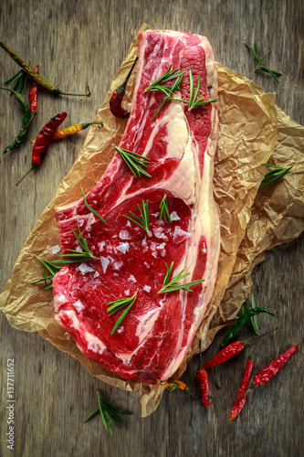 Fresh Raw Beef bone rib roughly choppid on on baking paper. photo