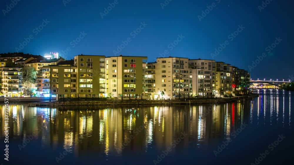 Time Lapse of apartment buildings on the waterfront at night Time Lapse of apartment buildings on the waterfront at night