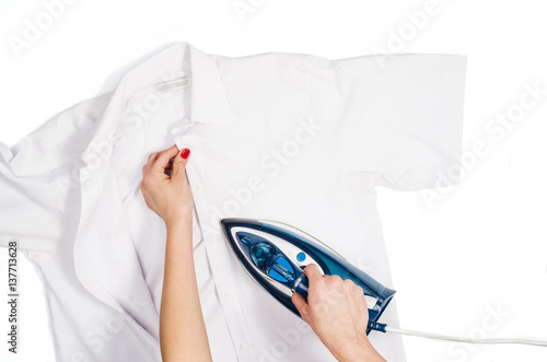Fotografie, Obraz Female hand ironing clothes top view isolated on white background