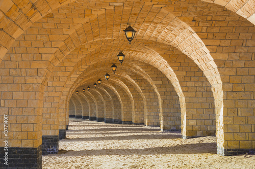 Fotografering The arched stone colonnade with lanterns