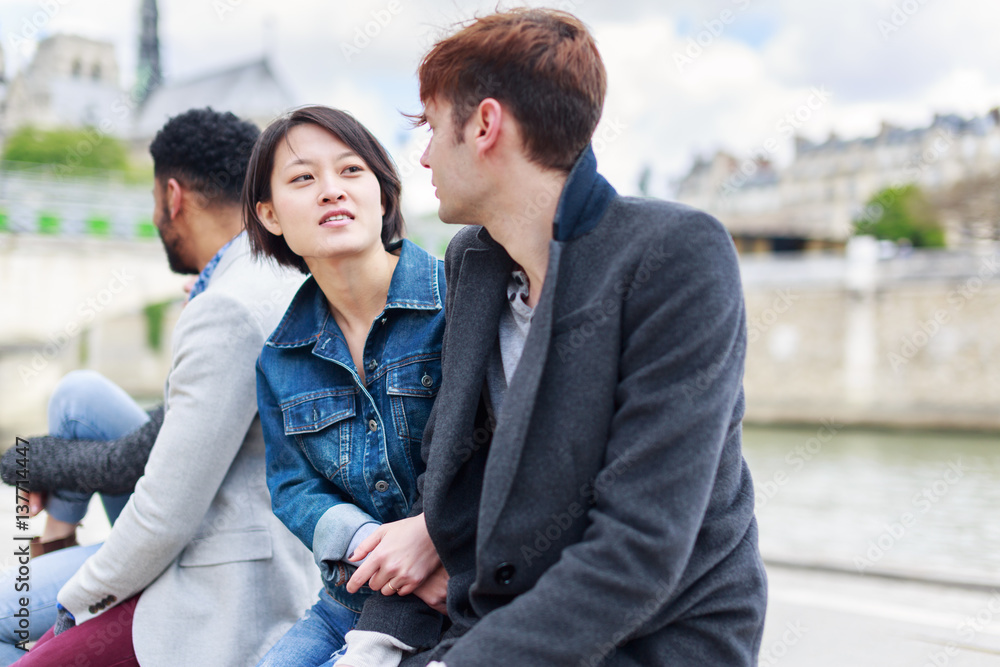 Multi-ethnic Group Of Friends Having Fun In Paris Along Seine Multi-ethnic Group Of Friends Having Fun In Paris Along Seine