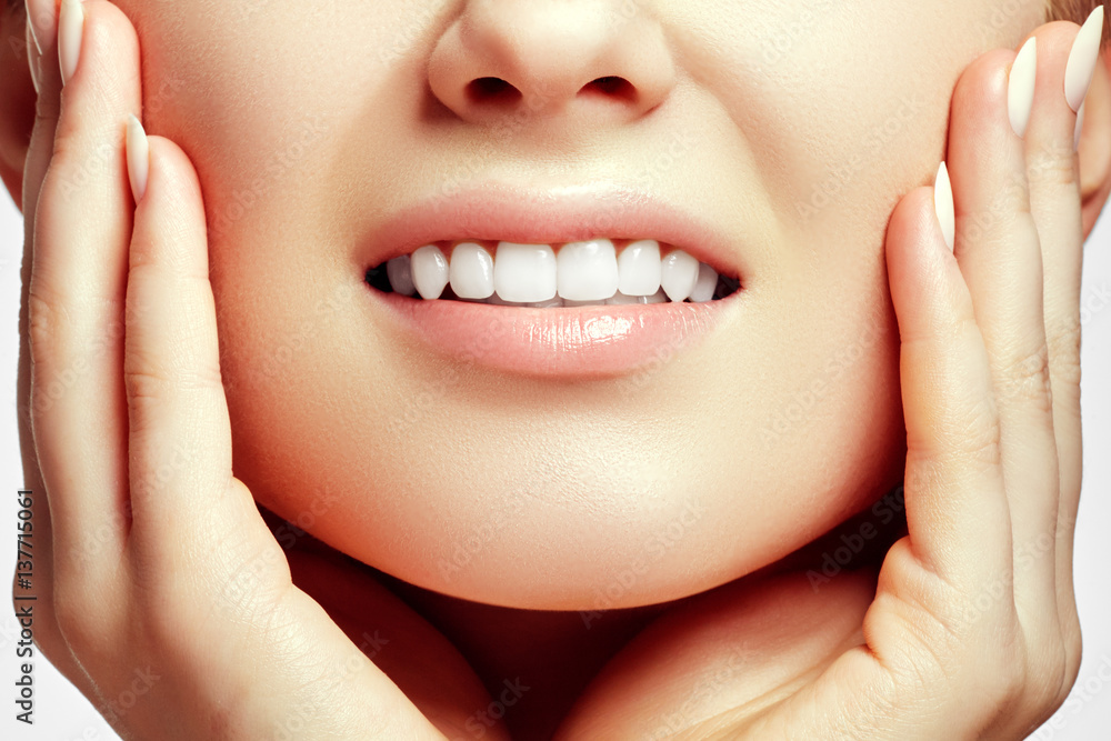 Fototapeta premium Part of the face close-up, toothy smile, concept after bleaching. Beauty care. Teeth whitening