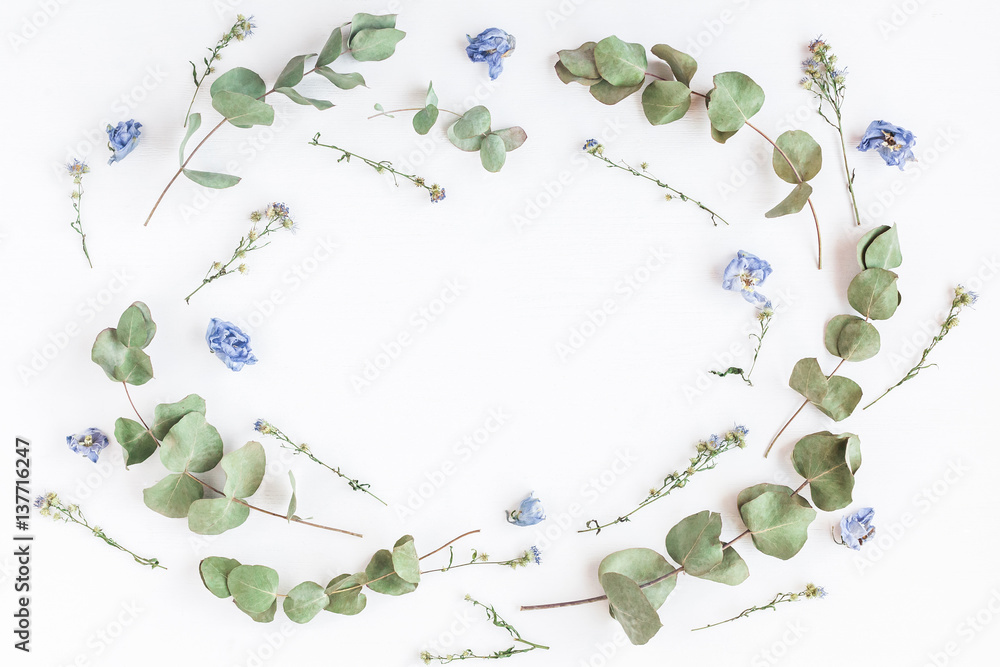 Naklejka Flowers composition. Frame made of dried flowers and eucalyptus branches on white background. Flat lay, top view