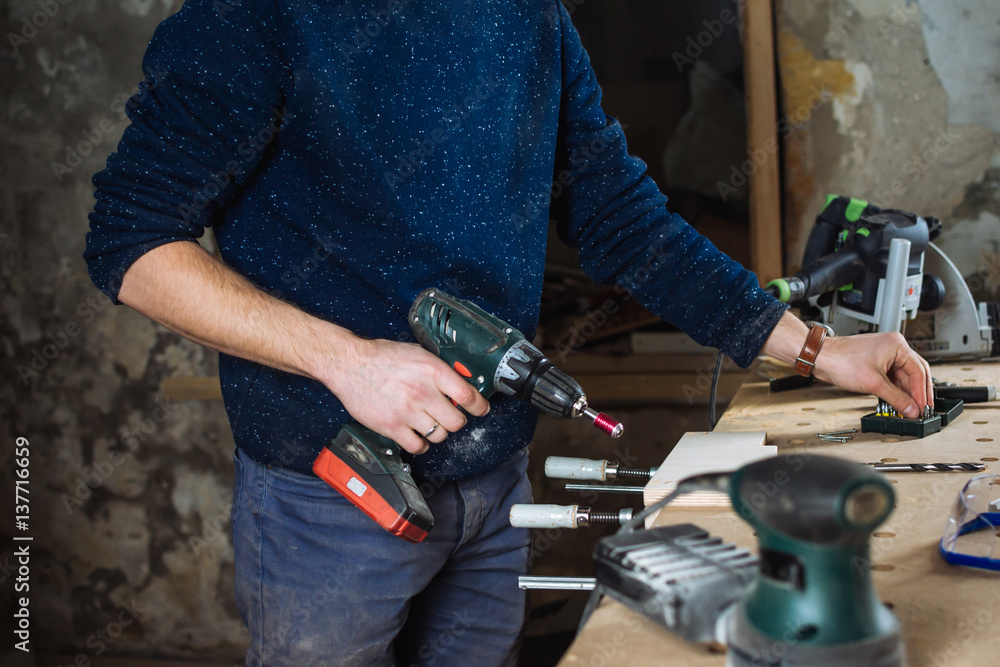 Man working with drill at the workshop