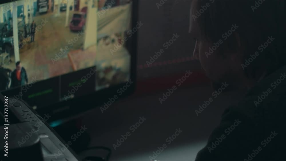 Close-up Of Male Security Guard with tablet pc While Monitoring Multiple CCTV Footage Close-up Of Male Security Guard with tablet pc While Monitoring Multiple CCTV Footage