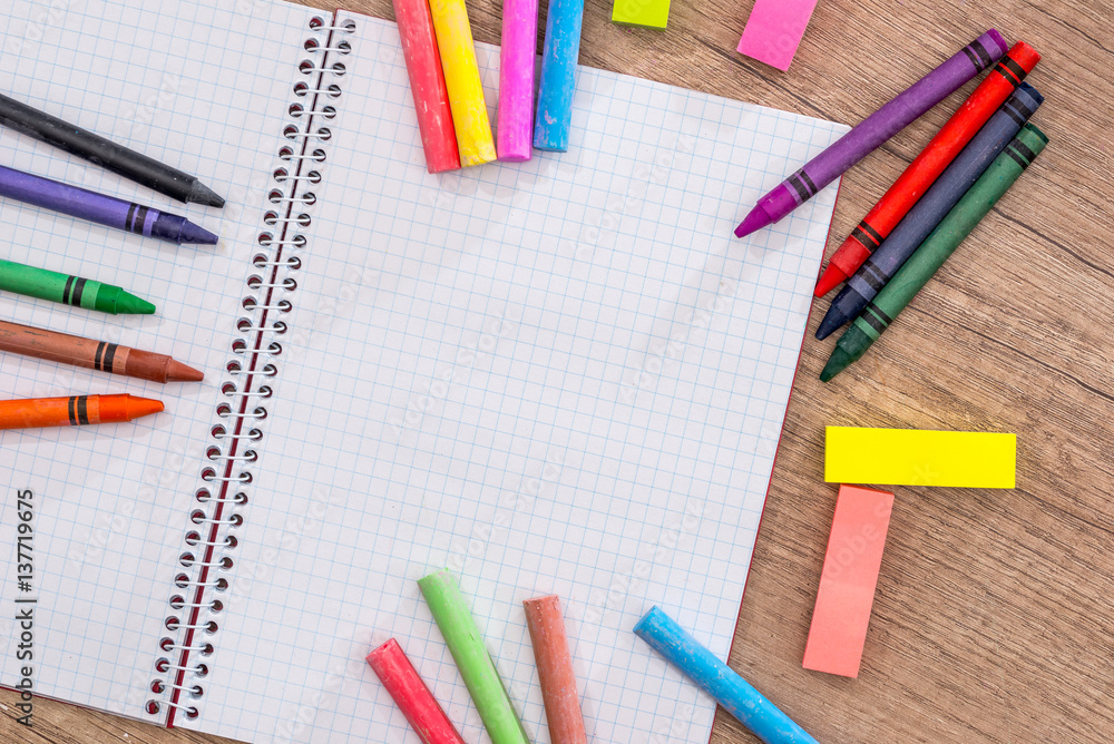 Blank notebook with pencils, chalk colour on wood table. Blank notebook with pencils, chalk colour on wood table.