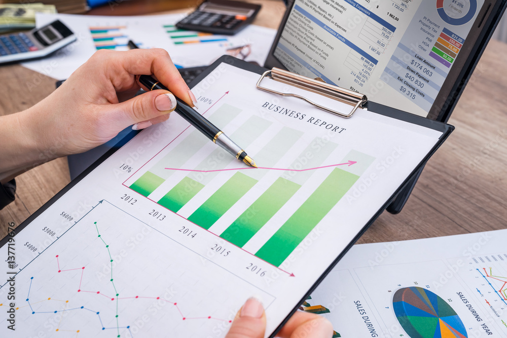 business woman working with business graph at office, financial report concept. business woman working with business graph at office, financial report concept.