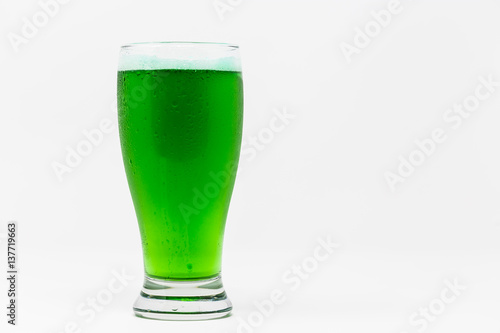 pilsner glass with green beer isolated on white background.