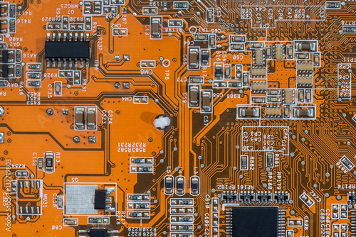 old orange motherboard as background. electronic components. photo