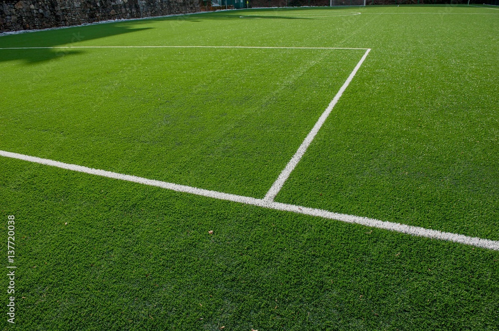 corner in the football field with artificial turf flag