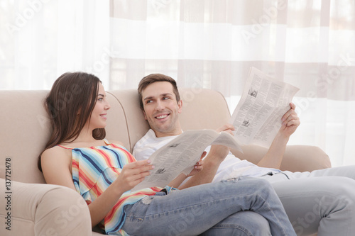 Happy couple resting on cou...