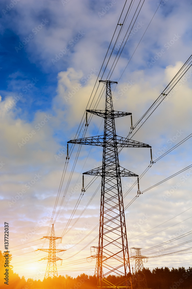 sunset with a silhouette of electricity pylon and power lines sunset with a silhouette of electricity pylon and power lines