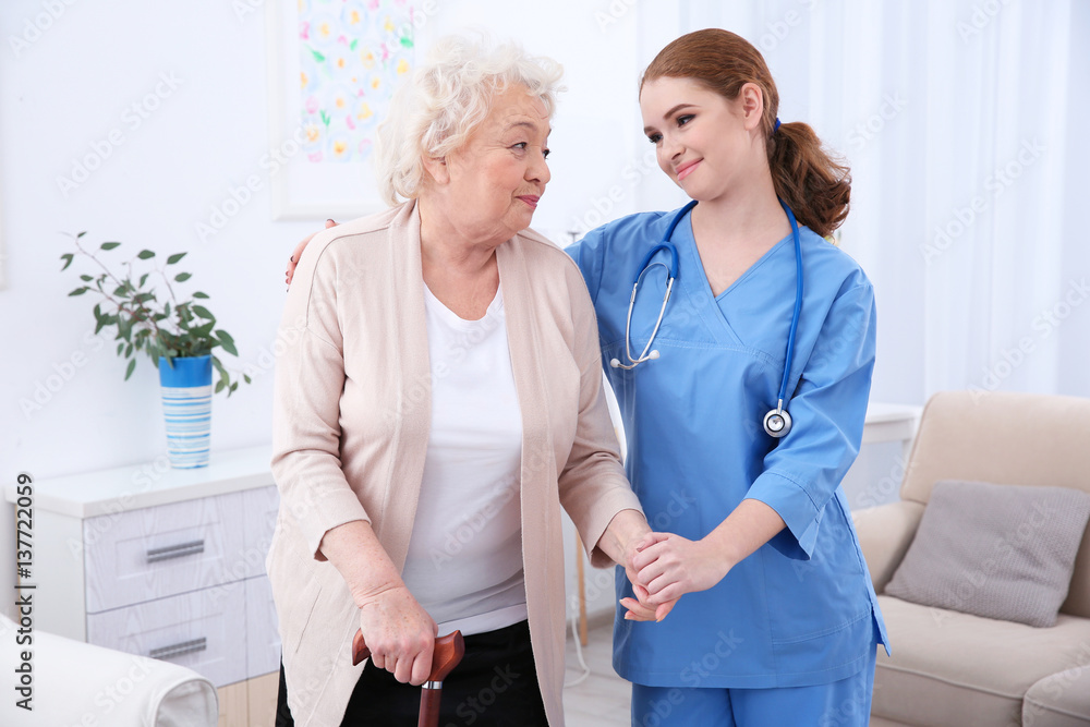 Fototapeta premium Nurse and elderly women in light room