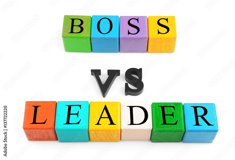 Lines of colorful wooden cubes and black letters forming text BOSS VS LEADER isolated on white Lines of colorful wooden cubes and black letters forming text BOSS VS LEADER isolated on white